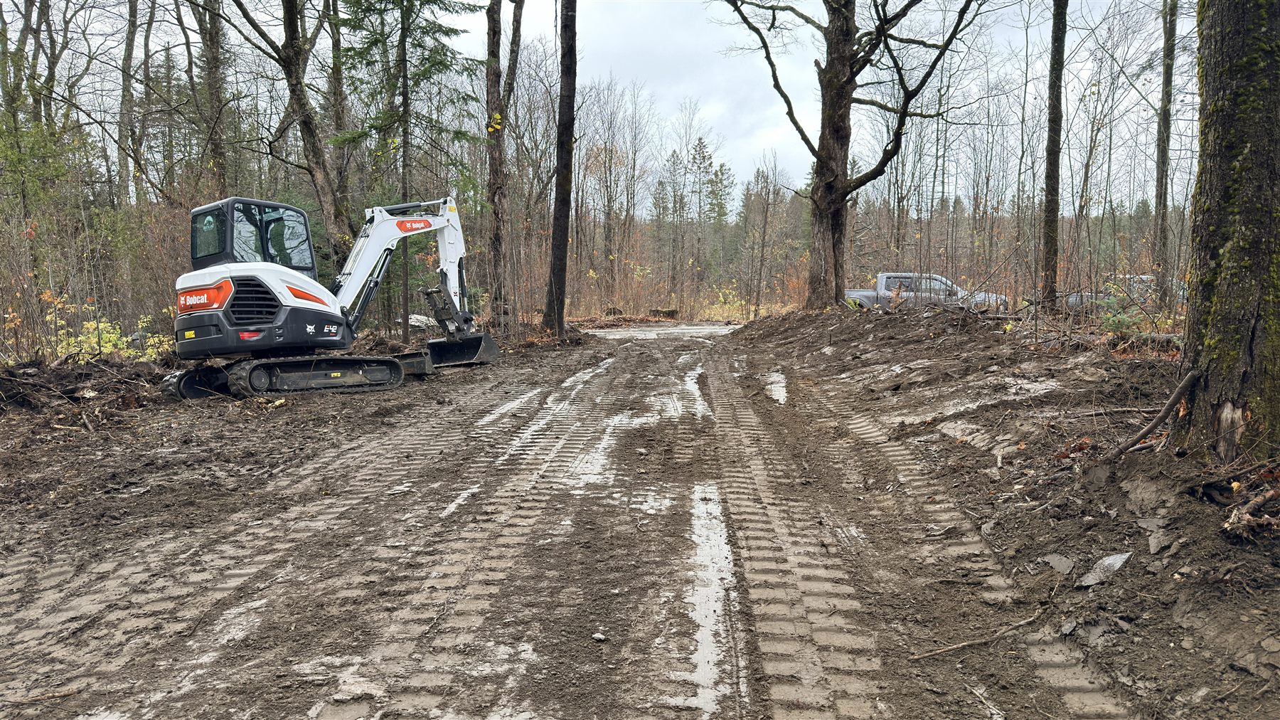 Freshly graded access road through a wooded Vermont property